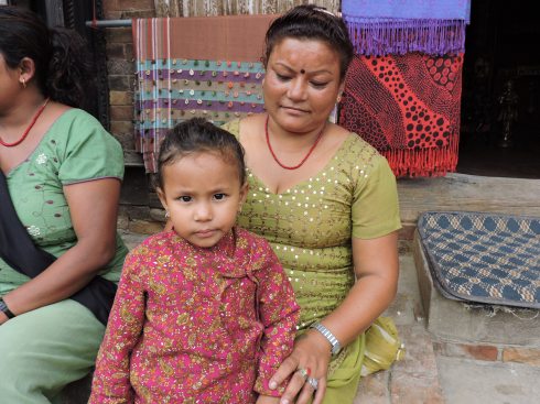 mother and daughter in front of a shop
