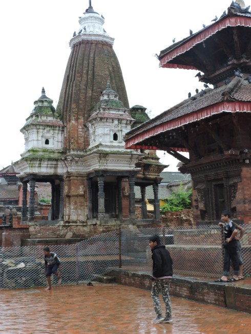 Playing soccer between the temples of Durbar Square, Patan