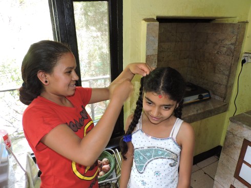 Januka helping Muskan do her hair